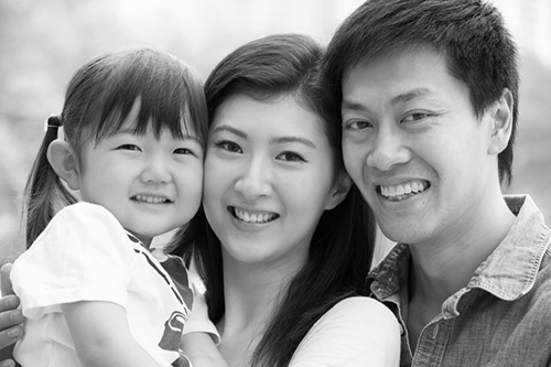 Portrait Of Chinese Family With Daughter In Park